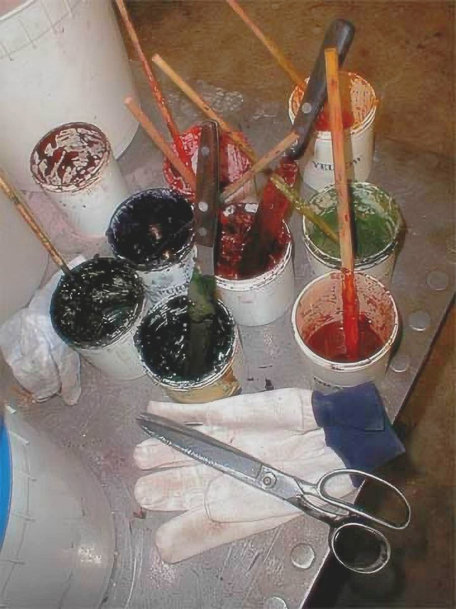 A set of open candy color jars with brushes, canvas gloves, and shears used in traditional candy-making at Hammond&rsquo;s Factory in North Denver.